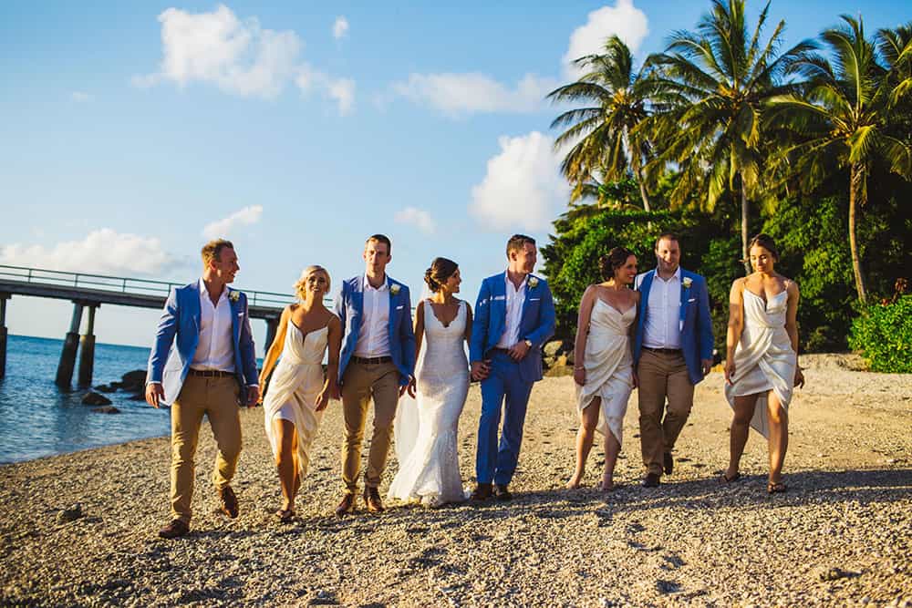bridal party walking on beach